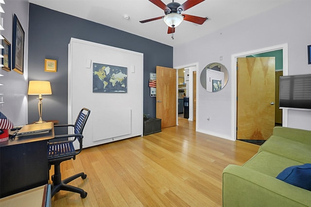 office with a ceiling fan and light wood-type flooring