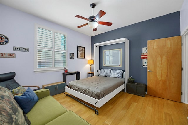 bedroom with a ceiling fan and wood finished floors