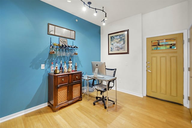 bar featuring baseboards and wood finished floors