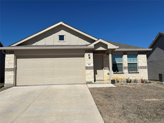 ranch-style house featuring board and batten siding, stone siding, and concrete driveway