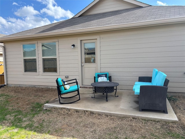 back of house featuring a patio and a shingled roof