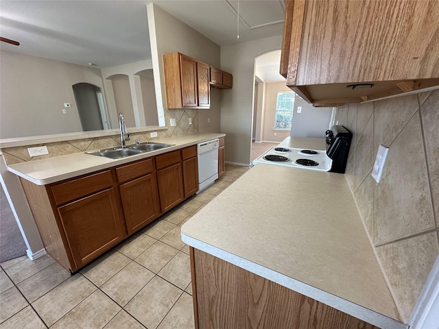 kitchen with brown cabinets, light countertops, and a sink