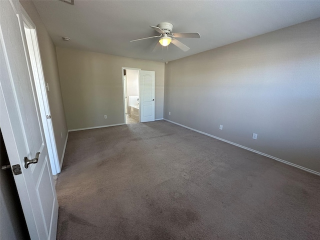 unfurnished bedroom with carpet, baseboards, a ceiling fan, and ensuite bathroom