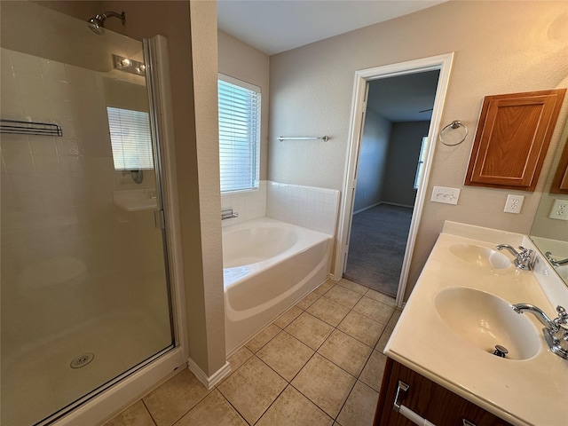 bathroom featuring tile patterned flooring, a sink, and a shower stall