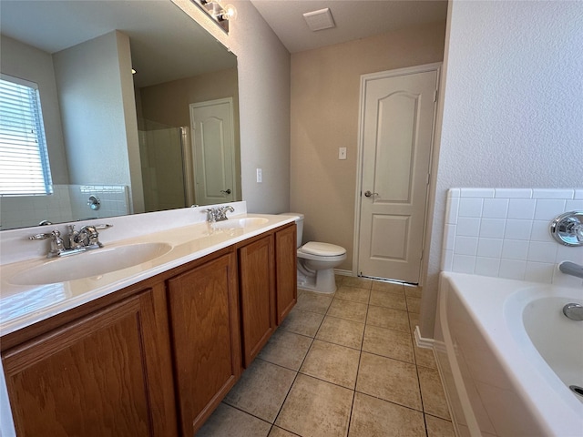 full bath with double vanity, toilet, a sink, and tile patterned floors