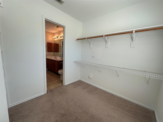 spacious closet with carpet and visible vents