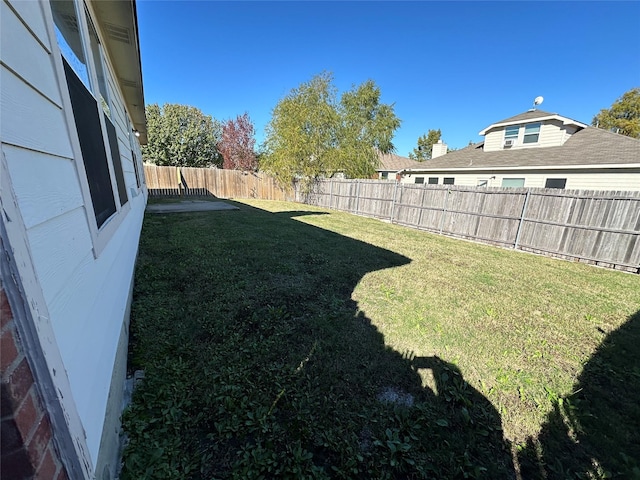 view of yard with a fenced backyard