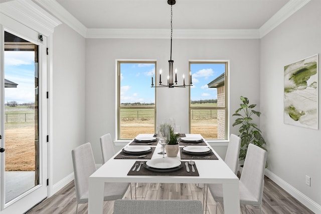 dining space featuring a chandelier, plenty of natural light, and wood finished floors