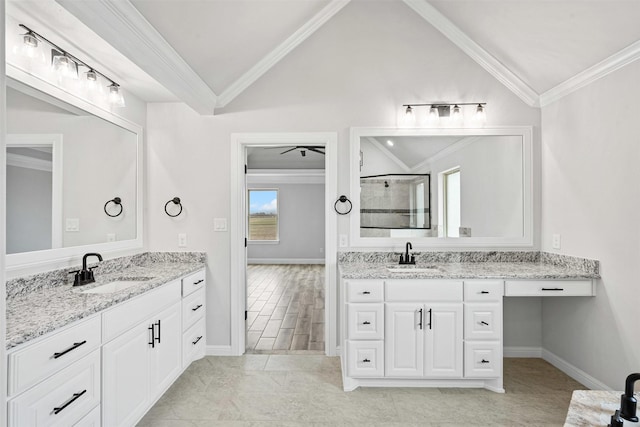 full bathroom with ornamental molding, a stall shower, vaulted ceiling, and a sink