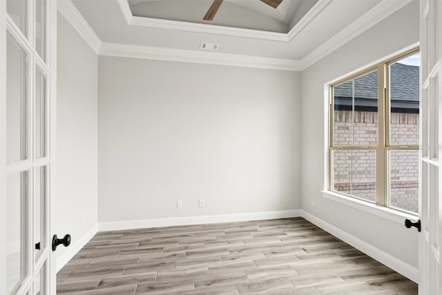 spare room featuring a healthy amount of sunlight, light wood-style floors, and baseboards