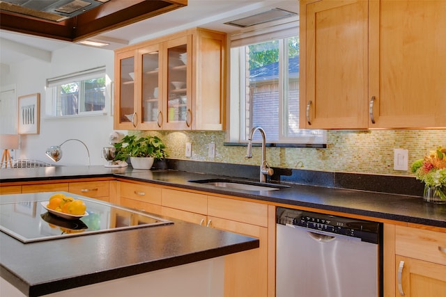 kitchen with glass insert cabinets, dark countertops, a sink, and stainless steel dishwasher