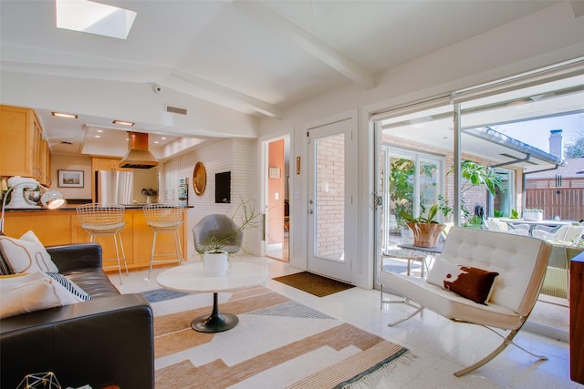 living room featuring lofted ceiling with skylight and visible vents