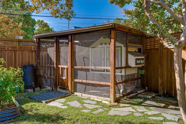 view of outbuilding with fence and an outdoor structure