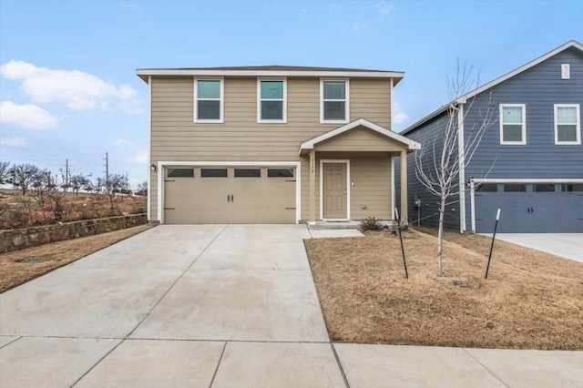 traditional-style home featuring concrete driveway and an attached garage