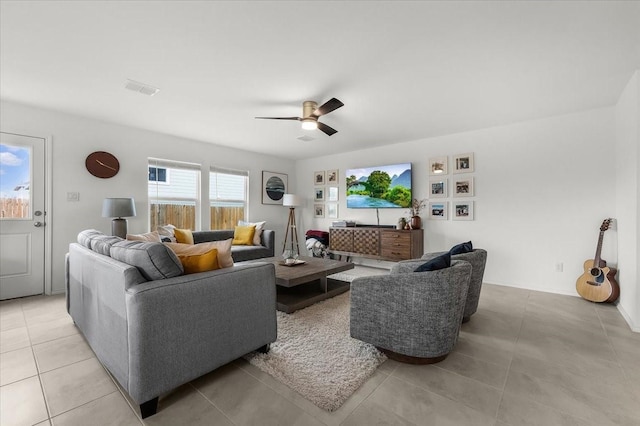 living area with visible vents, ceiling fan, and light tile patterned floors