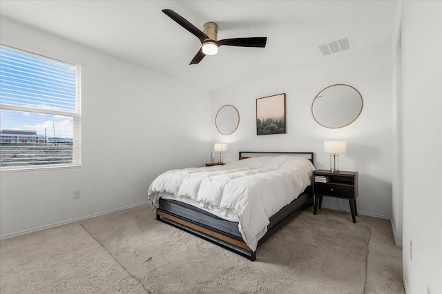 bedroom with ceiling fan, carpet floors, visible vents, and baseboards