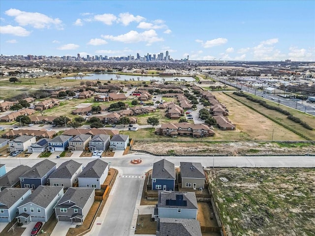 bird's eye view with a water view, a residential view, and a city view