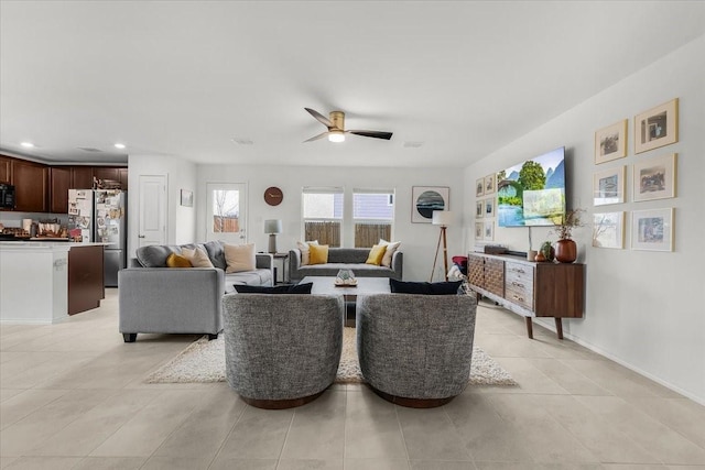 living area featuring recessed lighting, ceiling fan, baseboards, and light tile patterned floors