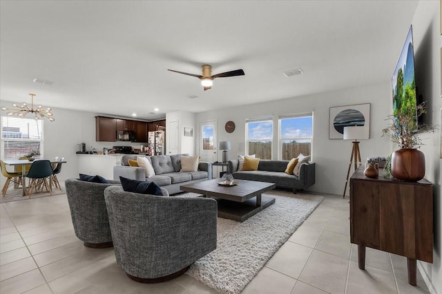 living area with light tile patterned floors, ceiling fan with notable chandelier, visible vents, and recessed lighting