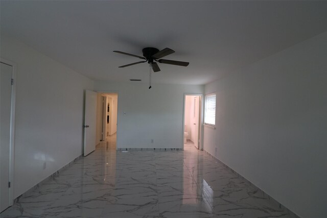 unfurnished room featuring marble finish floor, visible vents, and ceiling fan