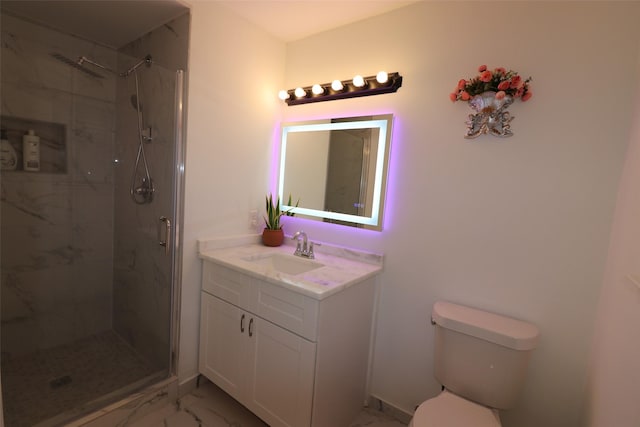 bathroom featuring marble finish floor, vanity, a marble finish shower, and toilet