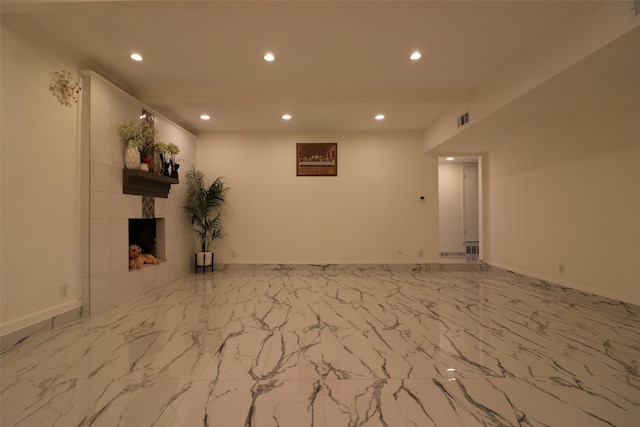 interior space featuring marble finish floor, recessed lighting, visible vents, a tiled fireplace, and baseboards