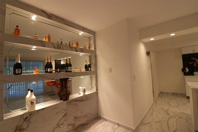 bar with marble finish floor, recessed lighting, and baseboards