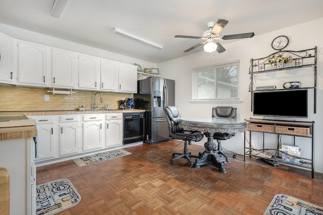 interior space featuring a sink and a ceiling fan