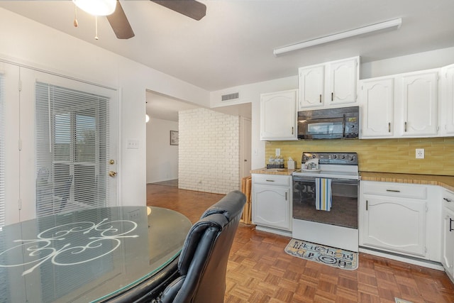 kitchen with black microwave, white range with electric cooktop, white cabinetry, and decorative backsplash