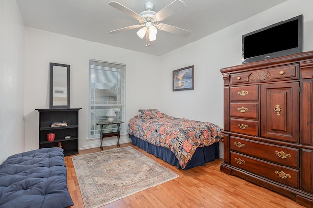 bedroom with ceiling fan and light wood-style flooring