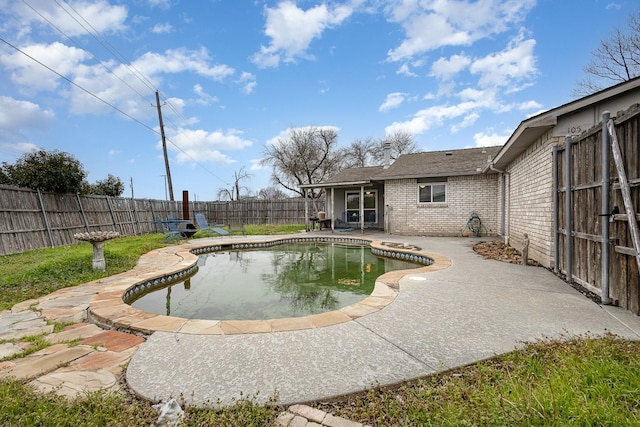 view of swimming pool with a fenced backyard, a fenced in pool, and a patio