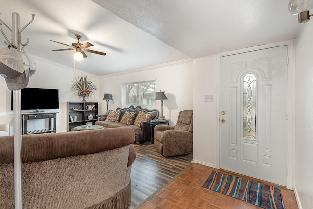 living room with baseboards, ornamental molding, and a ceiling fan