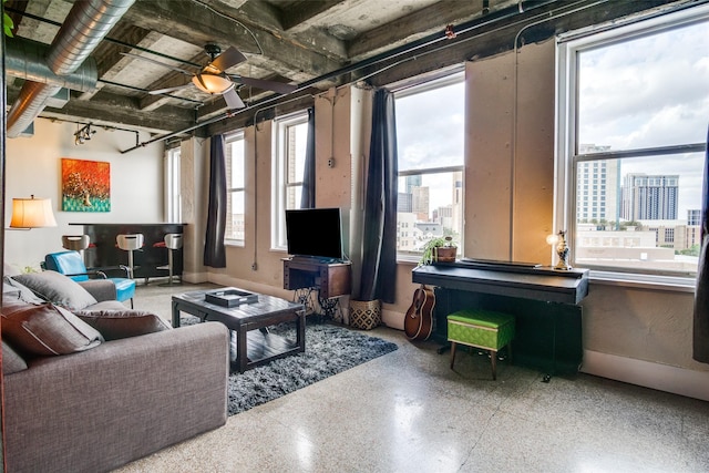 living room featuring baseboards and speckled floor