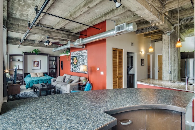 kitchen with a ceiling fan, visible vents, open floor plan, freestanding refrigerator, and pendant lighting