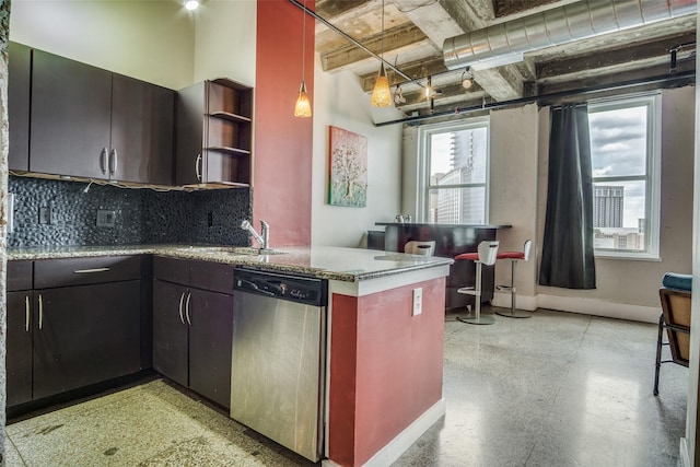 kitchen with a sink, hanging light fixtures, dishwasher, open shelves, and tasteful backsplash