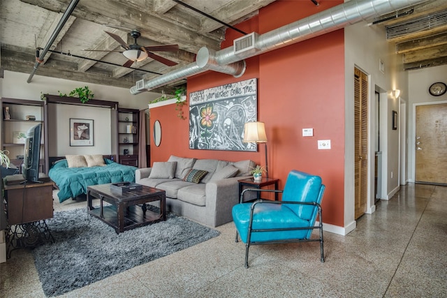 living room with a ceiling fan, visible vents, baseboards, and speckled floor