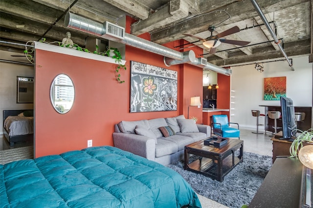 living room with ceiling fan, visible vents, and baseboards