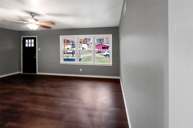 entryway featuring dark wood-style flooring, a ceiling fan, and baseboards