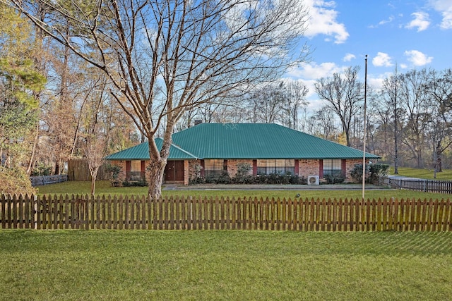 5651 Bretwood Dr, Keithville, LA 71047 - view of front of house with a fenced front yard, a front lawn, and metal roof