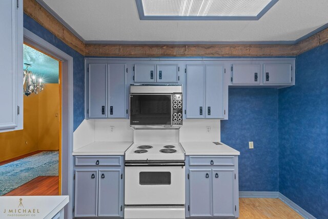 5651 Bretwood Dr, Keithville, LA 71047 - kitchen with light countertops, light wood-style floors, white electric range, and baseboards