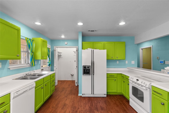 kitchen with white appliances, visible vents, dark wood-style floors, light countertops, and a sink