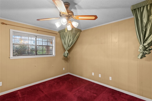 unfurnished room featuring carpet, crown molding, a textured ceiling, and baseboards