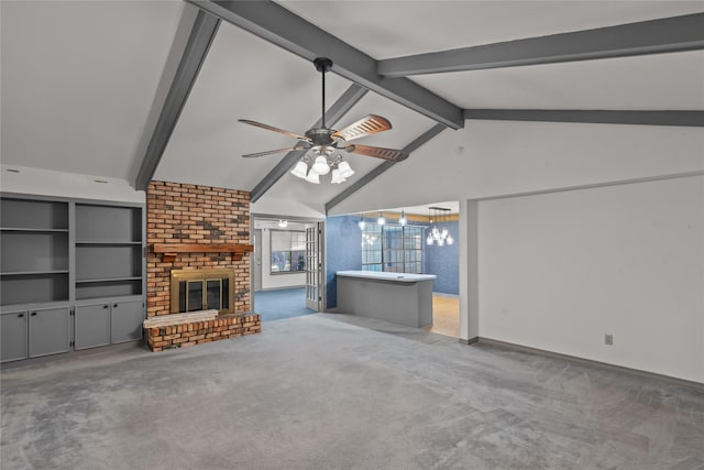 unfurnished living room with lofted ceiling with beams, a brick fireplace, carpet flooring, ceiling fan, and baseboards