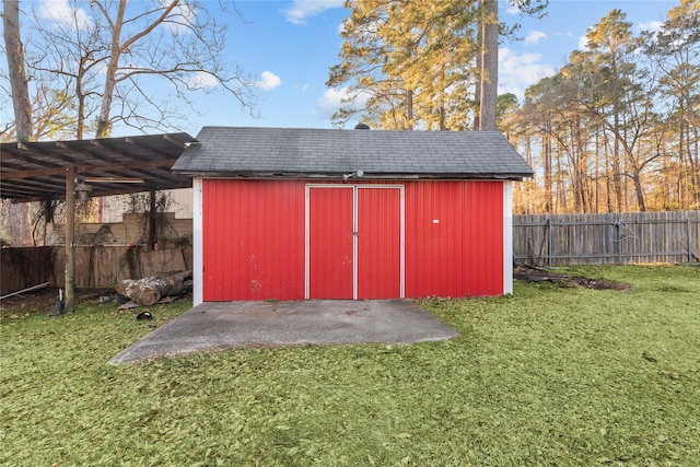 view of shed with fence and a pergola