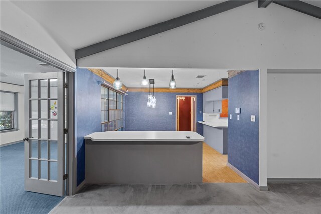 kitchen with a peninsula, a sink, visible vents, electric stove, and light countertops