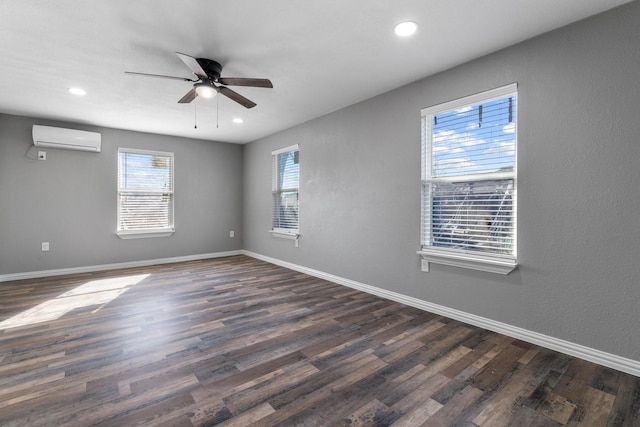 empty room with recessed lighting, baseboards, dark wood-type flooring, and a wall mounted AC