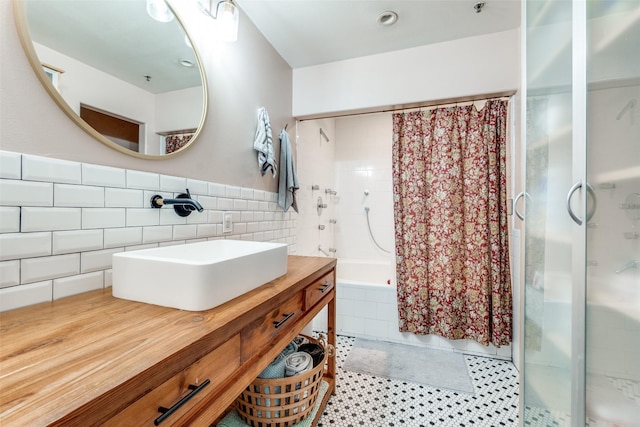 full bath with vanity, tiled shower / bath combo, tile walls, and tile patterned flooring