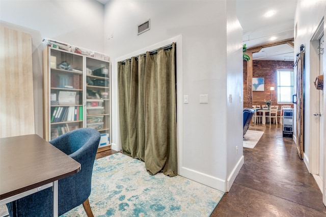 office space with baseboards, visible vents, recessed lighting, and concrete flooring