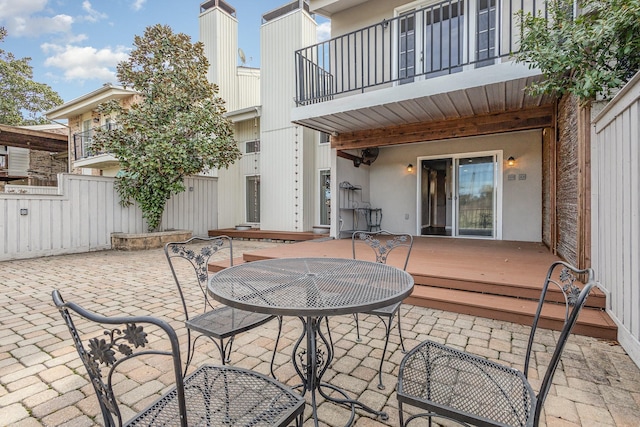 view of patio / terrace with fence and a balcony