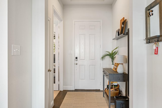 interior space featuring baseboards and dark wood-type flooring